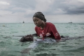 Swim instructor Siti, 24, helps a girl float on Thursday, November 17, 2016 in the Indian Ocean off of Nungwi, Zanzibar.
