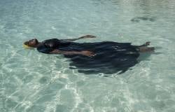 A young woman learns to float on Thursday, November 24, 2016 in the Indian Ocean off of Nungwi, Zanzibar.