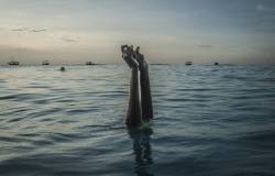 Swim instructor Chema, 17, snaps her fingers as she disappears underwater on Wednesday, December 28, 2016 in Nungwi, Zanzibar.