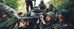 Ukrainian soldiers carried out of the battlefield car driver of armored car of landing troops, which suffered from grenade shot during the assault of Ilovaysk, Aug. 10, 2014.(UKR) 10.08.2014Солдати батальйону спеціального призначення НГУ «Донбас» витягують бійців 51 ОМБр (окремої механізованої бригади) з БМП, яку було атаковано з РПГ (ручний протитанковий гранатомет) під час першого штурму міста Іловайськ. Зліва, тримає носилки, Шульц (загинув), справа - Золотий, правіше - Мега (загинув), позаду - Тринадцятий. Всі бійці екіпажу БМП потрапили у полон при виході з Іловайська, в грудні 2014 їх обміняли.