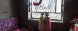 AL ABTHI BUILDING, IBB CITY, YEMEN - 21 APRIL 2017.
 
Children peer out of a window in a former government building in the suburbs of Ibb. The building was provided by local authorities to house 53 displaced families who fled here from Taizz after heavy fighting flared up in the summer of 2015.
 
The building has no electricity or running water. The displaced families installed solar panels on the roof of the building to provide power for rudimentary lighting at night. Many of the children help their parents by collecting water and tending to the younger children in the building.