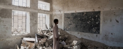 AAL OKAB SCHOOL , SAADA CITY, YEMEN - 24 APRIL 2017
 
A student at the Aal Okab school stands in the ruins of one of his former classrooms, which was destroyed during the conflict in June 2015. Students now attend lesson in UNICEF tents nearby.