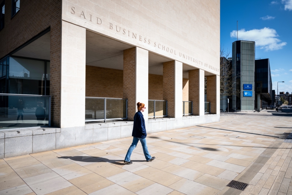 An empty urban scene such as this, taken during Lockdown, is unusual as there would normally be traffic and bustling pedestrians. The presence of one, solitary person emphasizes the emptiness. 