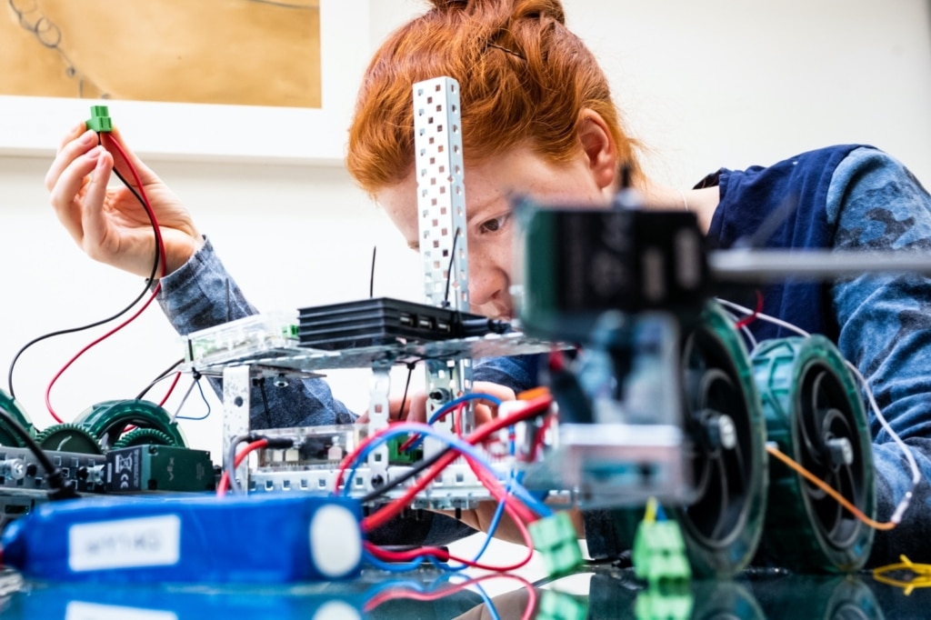 My daughter working on her school robot project during Lockdown. I had to persuade her out of her bedroom to work on her robot on the kitchen table because there was brighter light and I had more room to crouch down so that I could fill the frame using a 35mm lens. 