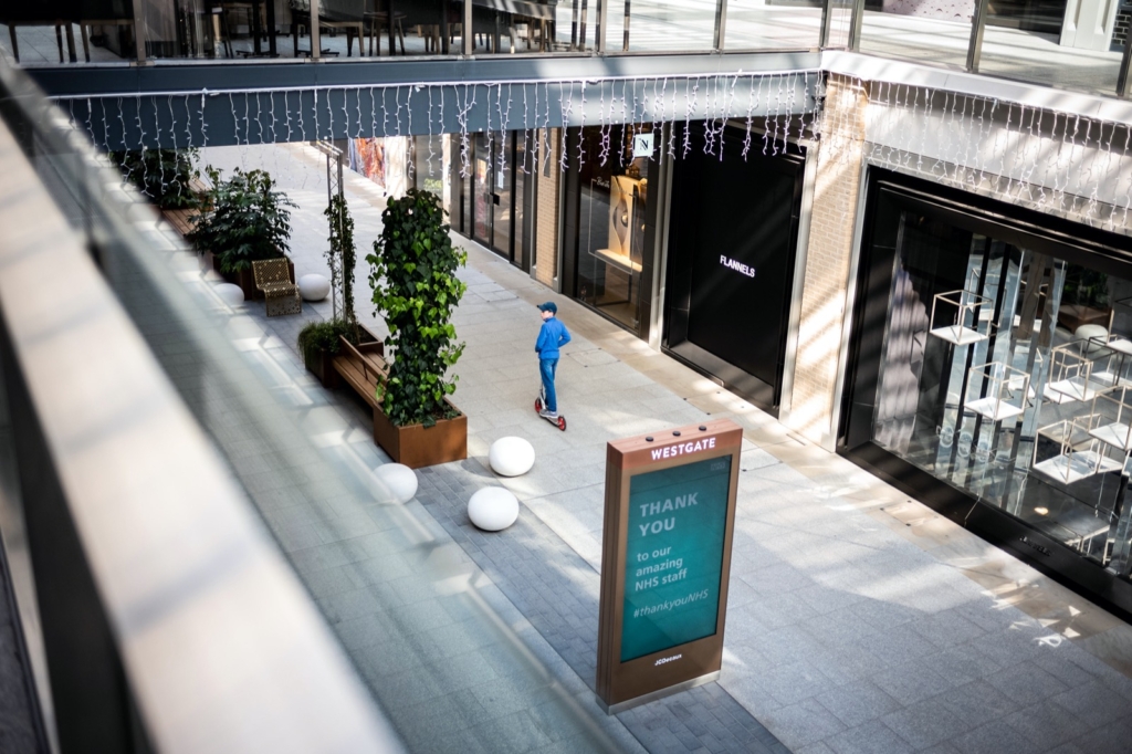 Taken in a normally busy shopping Mall gives a sense of walkways and shops with one small lone figure scooting around it. It has a melancholy feeling about it, a kid normally scoots for fun, but that here is contrasted by the reason the mall was empty, because of a global pandemic. 