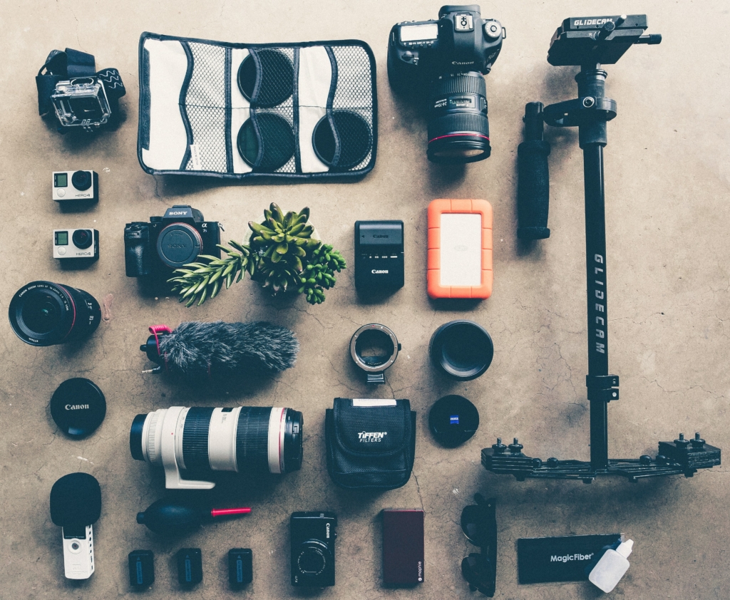 Photography gear laid out on a grey surface 