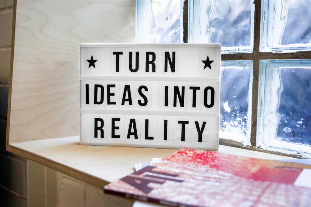 A white board displaying turn ideas into reality