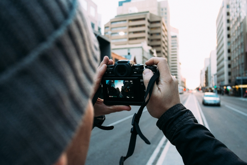 Over the head shot of a person holding a DSLR