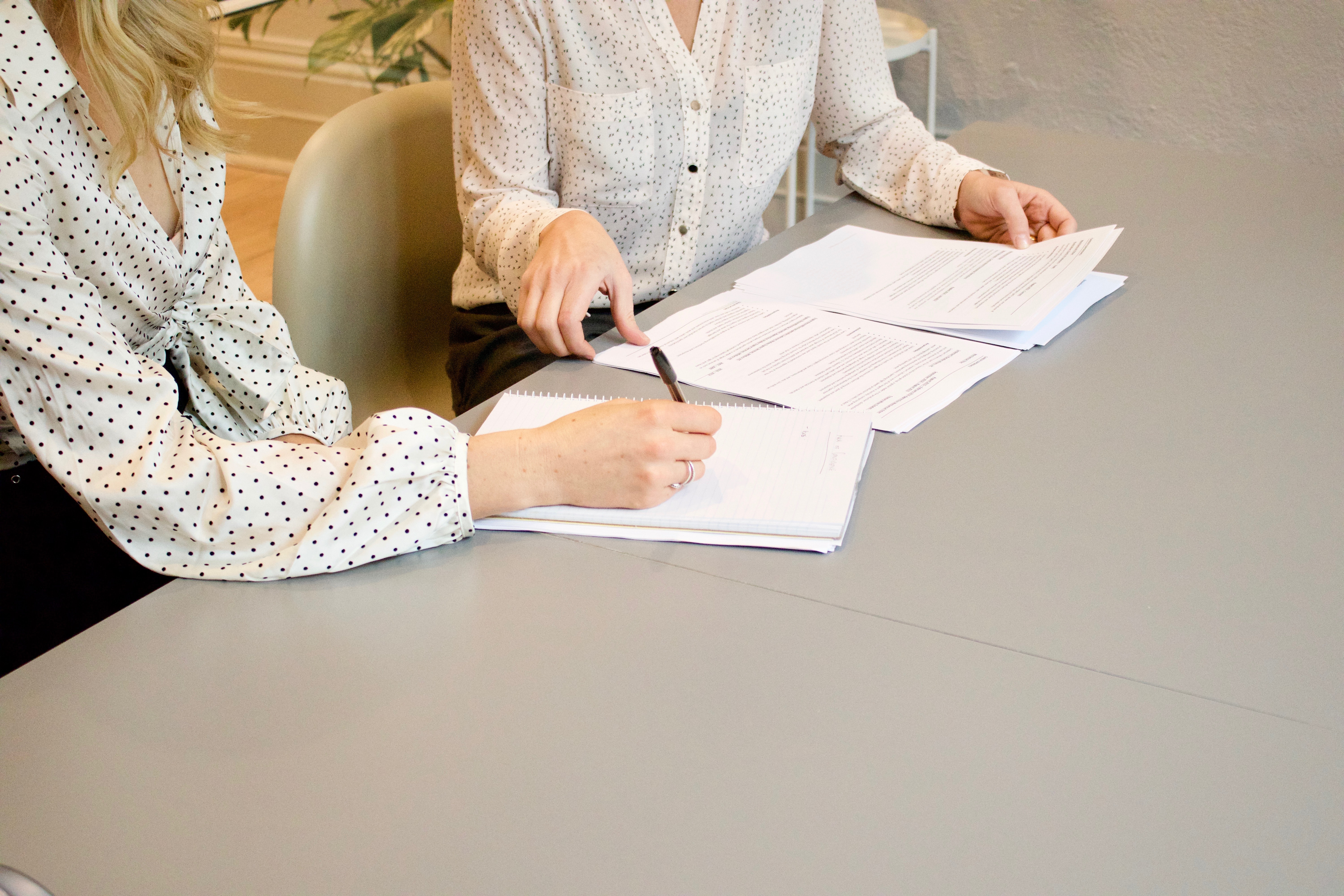 Two people discussing paperwork