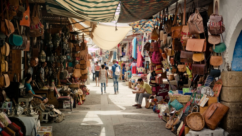 A souk, showcasing all sorts of items for sale on a sunny day.